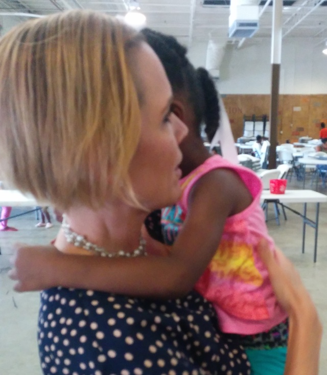 Linda Newton holds new friend at City of Refuge. Courtesy, @GAOpportunity